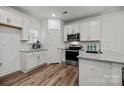 Bright kitchen features stainless steel appliances, granite countertops and hardwood flooring at 3124 Butler Hill Dr, Matthews, NC 28105