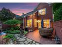 Inviting brick patio with comfortable seating, lush garden, and outdoor grilling area, perfect for entertaining at 3128 Ethereal Ln, Charlotte, NC 28226
