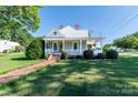 Charming home featuring a landscaped front yard, brick pathway, and inviting front porch, perfect for relaxation at 328 E Center Ave, Mooresville, NC 28115