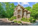 Charming home with stone accents, lush landscaping, and a welcoming walkway at 335 Whisper Lake Dr, New London, NC 28127