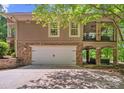 Spacious two-car garage and covered patio with outdoor entertainment space at 335 Whisper Lake Dr, New London, NC 28127