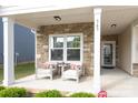 Inviting front porch with stone accents, seating, and a cozy atmosphere at 363 Bellingrath Blvd, Rock Hill, SC 29730