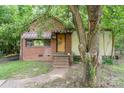 Charming bungalow with brick and siding, featuring a covered porch and mature trees at 3924 Tillman Rd, Charlotte, NC 28208