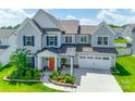 Beautiful two-story home featuring a manicured lawn, attached two car garage, and a covered front porch at 4023 Spring Garden St, Fort Mill, SC 29715