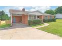 Beautiful brick home featuring a carport, covered entry, and well-maintained landscaping at 405 W Ormand Ave, Bessemer City, NC 28016