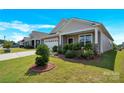 Charming single-story home with a two car garage and a well-manicured front yard with healthy green shrubbery at 4243 Merrivale Dr, Lancaster, SC 29720