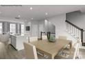 Open dining area with modern table set, flowing into the living room and kitchen at 5030 Grain Orchard Rd # 3025C, Indian Trail, NC 28079