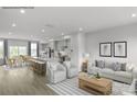 Open-concept living room features hardwood floors, neutral decor, and lots of light at 5030 Grain Orchard Rd # 3025C, Indian Trail, NC 28079