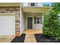 Up-close view of a home's front entrance, featuring a dark door and landscaped surroundings at 6322 Sydney Mae Ln, Charlotte, NC 28262