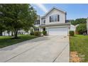 Well-maintained home with an expansive driveway leading to an attached two-car garage at 6332 Sackett Way, Charlotte, NC 28269