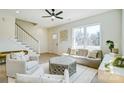 Bright living room with a large window, plush sofa, and access to the staircase at 709 Catawba St, Lincolnton, NC 28092