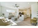 Bright, open-concept living room with modern furniture and hardwood floors that flows into the kitchen area at 709 Catawba St, Lincolnton, NC 28092