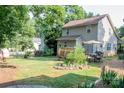 A lush backyard with a deck, patio furniture, and ample space for outdoor activities at 7691 Red Robin Trl, Denver, NC 28037