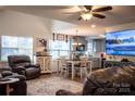 Open-concept living room and kitchen with wood floors and a cozy, inviting atmosphere at 7691 Red Robin Trl, Denver, NC 28037