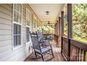 Inviting covered porch with rocking chairs and a ceiling fan, perfect for relaxing at 7691 Red Robin Trl, Denver, NC 28037