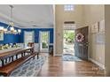 Dining room features hardwood floors, bright windows, and a decorative light fixture at 10206 Linksland Dr, Huntersville, NC 28078