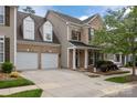 Charming brick townhome with a well-manicured lawn and attached two-car garage at 10206 Linksland Dr, Huntersville, NC 28078
