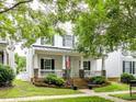 Inviting single-Gathering home with stone accents, an American flag, and a cozy front porch at 10515 Royal Winchester Dr, Charlotte, NC 28277