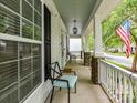 Cozy front porch featuring stylish seating and a view of the neighborhood street at 10515 Royal Winchester Dr, Charlotte, NC 28277