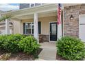 Inviting front porch with decorative stone, American flag, and stylish seating area at 107 Sequoia St, Mooresville, NC 28117