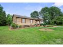 Classic home with a covered porch, green lawn, and shady trees at 112 Gays Chapel Rd, Statesville, NC 28625