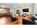 Comfortable living room featuring hardwood floors, a ceiling fan, and ample seating at 112 Gays Chapel Rd, Statesville, NC 28625