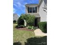 Well-maintained front yard with lush greenery and a welcoming entrance at 12222 Stratfield Place Cir, Pineville, NC 28134