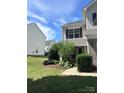 Charming home exterior with manicured lawn and beautiful landscaping at 12222 Stratfield Place Cir, Pineville, NC 28134