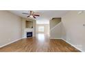 Bright living room showcasing a fireplace, hardwood floors, and an open floor plan with seamless flow at 12222 Stratfield Place Cir, Pineville, NC 28134