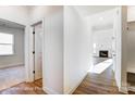 Bright hallway with hardwood floors leading to a cozy living area with a fireplace at 123 Prestwick Way # 42, Mooresville, NC 28115