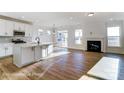 Open concept living area featuring a modern kitchen, fireplace, and ample natural light at 123 Prestwick Way # 42, Mooresville, NC 28115