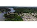 Picturesque aerial view showcasing the neighborhood's lake access and tree-lined streets at 137 Flora Vista Dr, Mooresville, NC 28117