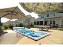 Relaxing backyard featuring a hot tub, a spacious deck, and mature landscaping perfect for entertaining at 137 Flora Vista Dr, Mooresville, NC 28117