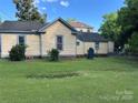 Green backyard offering ample space for outdoor activities with a vintage-style home at 142 Wylie St, Chester, SC 29706