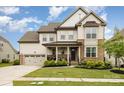 Charming two-story home with a landscaped yard and a welcoming front porch at 14228 Twin Eagles Ln, Charlotte, NC 28278
