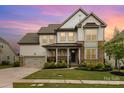 Charming two-story home with a landscaped yard and a welcoming front porch at 14228 Twin Eagles Ln, Charlotte, NC 28278