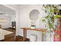 Inviting entryway with decorative table, round mirror, floral arrangement and hardwood floors at 1446 Downs Ave, Charlotte, NC 28205