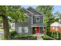 Beautiful gray two-story house with a vibrant red front door, complemented by lush greenery at 1446 Downs Ave, Charlotte, NC 28205