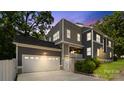 Stunning two-story home featuring a gray exterior with a spacious two-car garage and manicured landscaping at 1446 Downs Ave, Charlotte, NC 28205