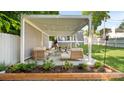Outdoor patio featuring comfortable lounge seating, a dining set, and privacy screens for intimate gatherings at 1446 Downs Ave, Charlotte, NC 28205