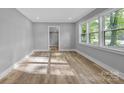 A bright and airy bedroom with wood-look floors and a view of the neighborhood at 1739 16Th Ne St, Hickory, NC 28601