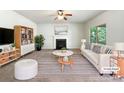 Inviting living room featuring a cozy fireplace, stylish furnishings, and plenty of natural light at 178 Wellshire St, Mooresville, NC 28115