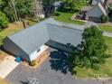 Aerial view of a one-story home with mature trees, long driveway, and a well-manicured lawn at 2011 20Th Street Ne Pl, Hickory, NC 28601