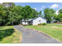 Single-story home featuring an attached garage and a lush green lawn on a sunny day at 2011 20Th Street Ne Pl, Hickory, NC 28601