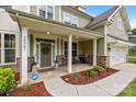 Inviting front porch with stone accents and a cozy seating area, perfect for relaxing outdoors at 20307 Creek Bend Edge Ct # 10, Matthews, NC 28105