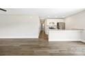 Open-concept living area showcases sleek hardwood floors, recessed lighting, and a modern kitchen at 209 S Gregory St # 3, Lancaster, SC 29720
