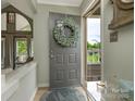 Inviting foyer with wreath and views into the living room and outdoor balcony at 212 W 10Th St # 3, Charlotte, NC 28202