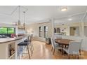 Open concept dining and living room with hardwood floors and neutral paint at 224 N Poplar St # 24, Charlotte, NC 28202
