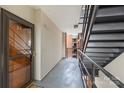 Hallway with door 24, stairs with black railings, and view of outside brick building at 224 N Poplar St # 24, Charlotte, NC 28202