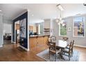 Open concept dining room with modern light fixture, breakfast bar, and windows offering natural light at 229 N Church St # 204, Charlotte, NC 28202